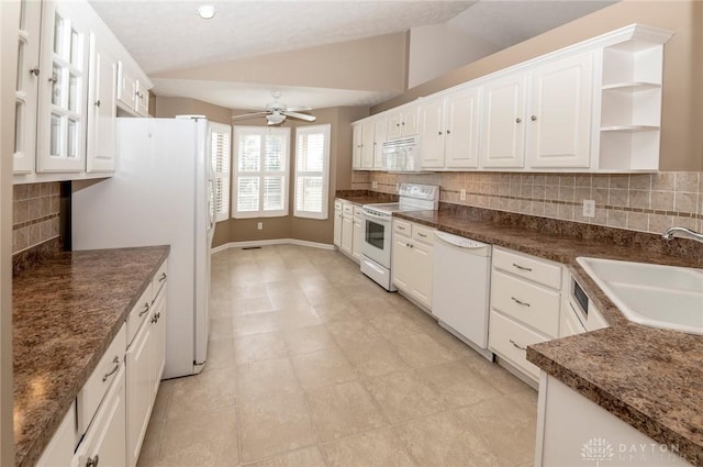 kitchen featuring white appliances, ceiling fan, sink, white cabinets, and lofted ceiling