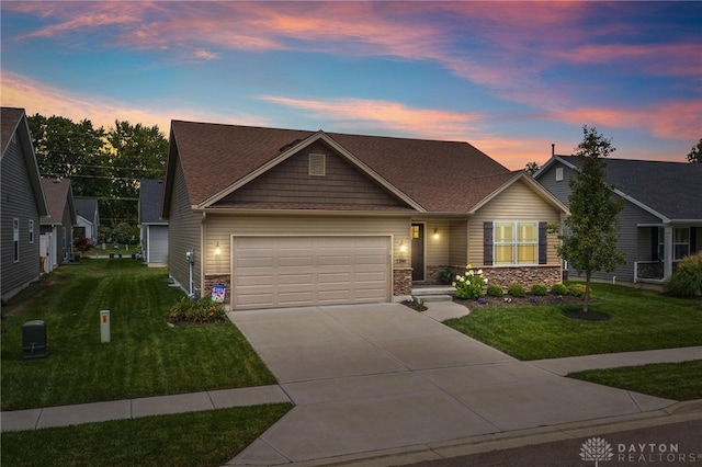 craftsman house featuring a garage and a lawn