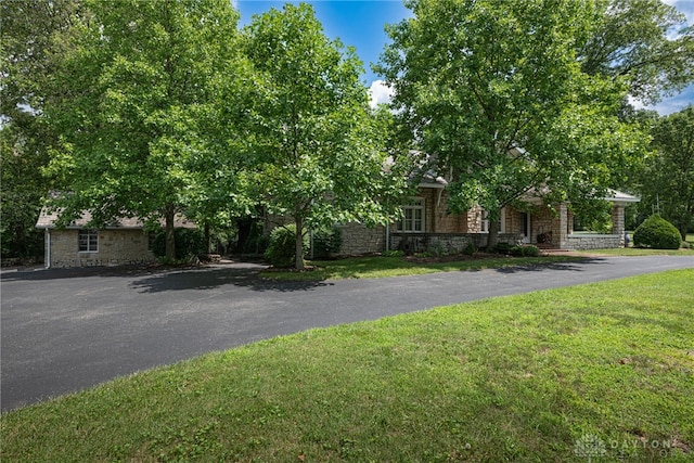 obstructed view of property featuring a front yard