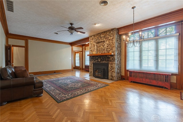 unfurnished living room with a fireplace, radiator heating unit, ceiling fan with notable chandelier, a textured ceiling, and light parquet floors