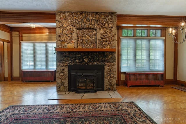 410 S Linden Ave, Miamisburg, OH 45342 - unfurnished living room with radiator, an inviting chandelier, a textured ceiling, and a wealth of natural light