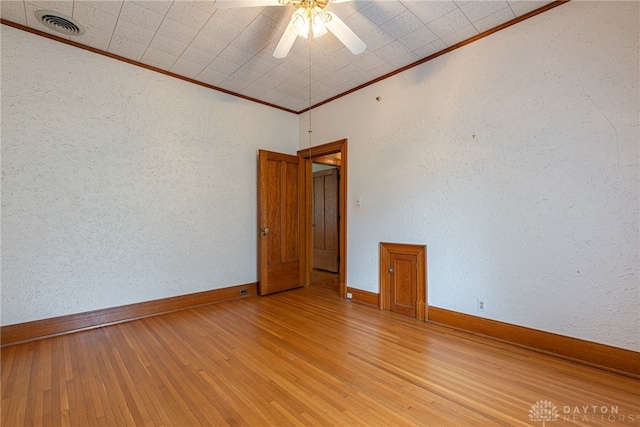 unfurnished room featuring ceiling fan, light hardwood / wood-style flooring, and crown molding