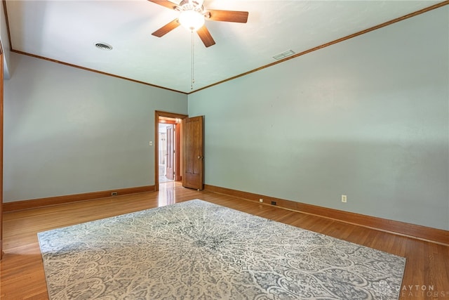 empty room with light hardwood / wood-style flooring, ceiling fan, high vaulted ceiling, and ornamental molding