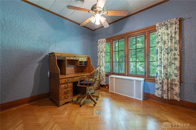 office with radiator heating unit, ceiling fan, ornamental molding, and light parquet floors