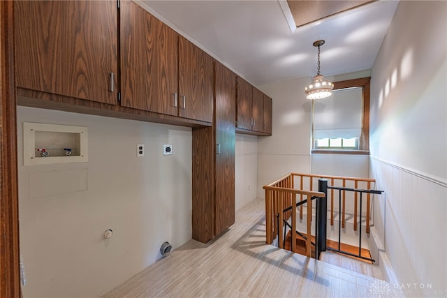 laundry room featuring electric dryer hookup, cabinets, hookup for a washing machine, a notable chandelier, and gas dryer hookup