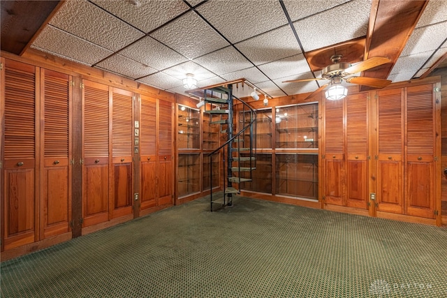 410 S Linden Ave, Miamisburg, OH 45342 - below grade area featuring ceiling fan, a paneled ceiling, wood walls, stairway, and carpet
