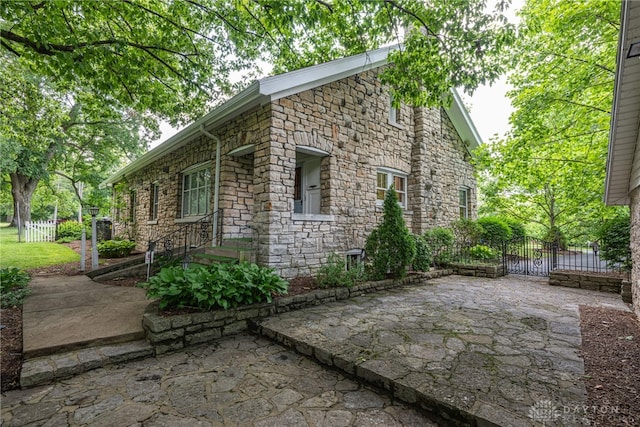 view of side of property with a patio