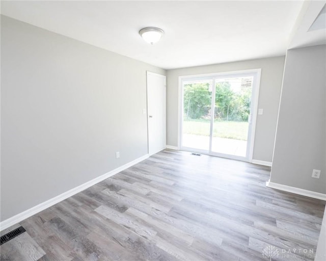 unfurnished room with light hardwood / wood-style flooring