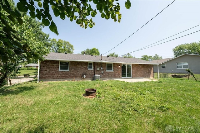 back of house featuring a patio area and a lawn