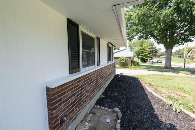 view of side of home with a lawn