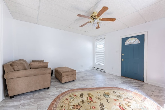 foyer featuring ceiling fan and a paneled ceiling