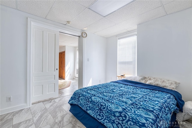 bedroom with a paneled ceiling