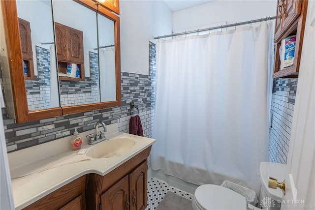 bathroom with vanity, toilet, a shower with shower curtain, and tile walls