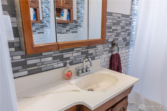 bathroom with decorative backsplash and vanity