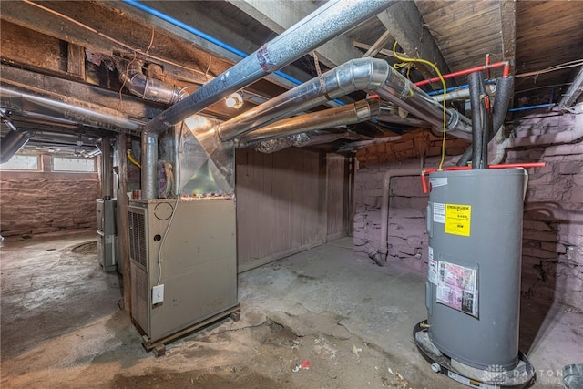 basement featuring heating unit and electric water heater