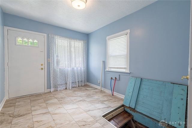 foyer featuring a textured ceiling