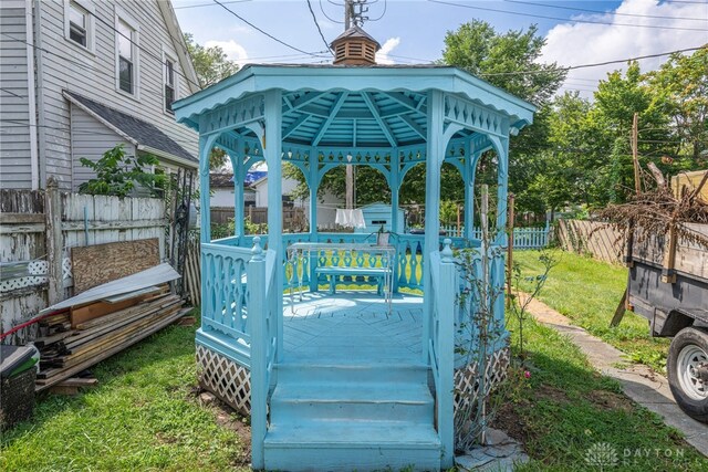 deck featuring a gazebo and a lawn