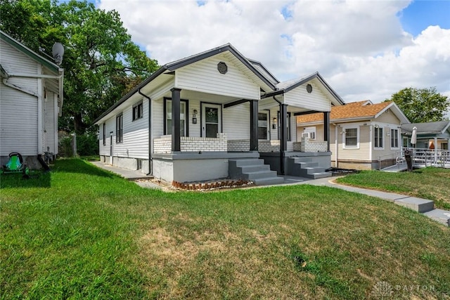 view of front of property with covered porch and a front yard