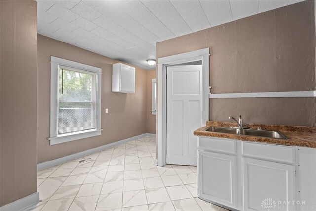 kitchen with white cabinetry and sink