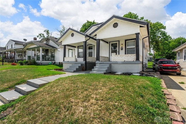 view of front of home with covered porch and a front yard