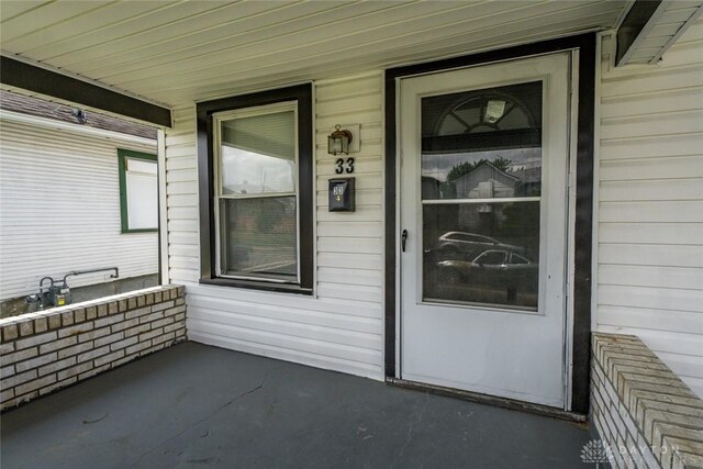 view of exterior entry with a porch