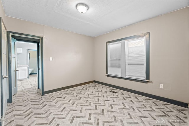 empty room featuring a textured ceiling