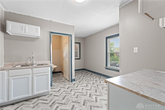 kitchen with white cabinetry and sink