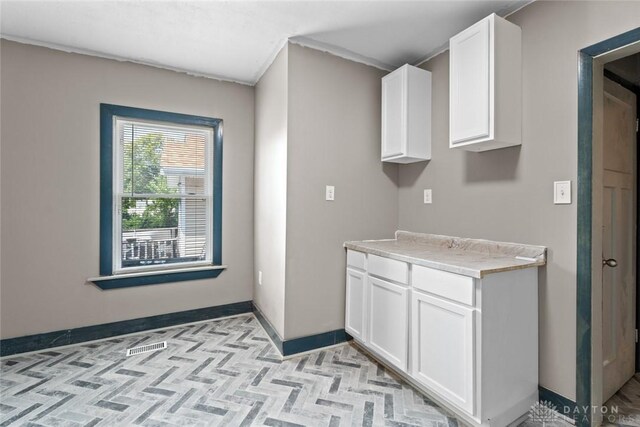 kitchen featuring white cabinets