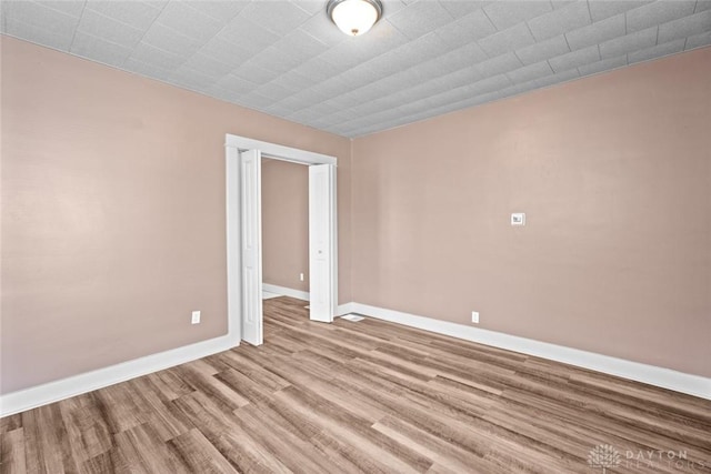 spare room with light wood-type flooring