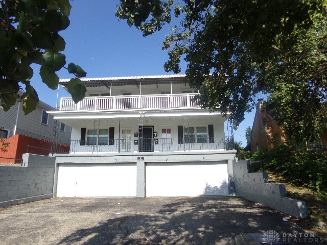 view of property featuring a balcony and a garage