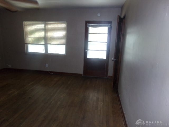 empty room with dark hardwood / wood-style floors