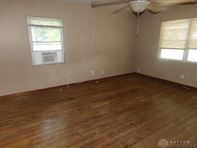 unfurnished room with cooling unit, dark hardwood / wood-style flooring, and ceiling fan