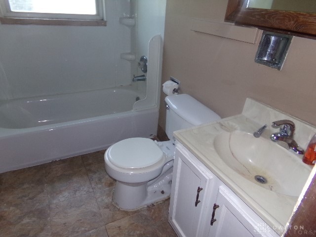 full bathroom featuring shower / bathing tub combination, vanity, and toilet