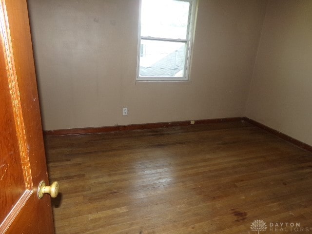 spare room with dark hardwood / wood-style floors