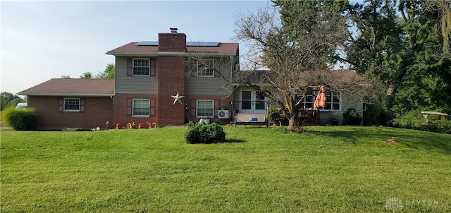 rear view of house with a yard