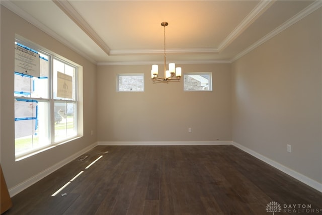 empty room featuring an inviting chandelier, crown molding, dark hardwood / wood-style flooring, and a tray ceiling