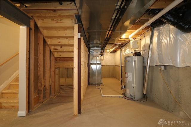 basement featuring water heater and heating unit