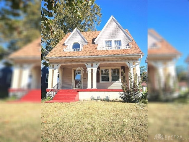 view of front of house with covered porch and a front yard