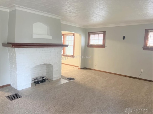 unfurnished living room featuring a textured ceiling, carpet floors, and ornamental molding