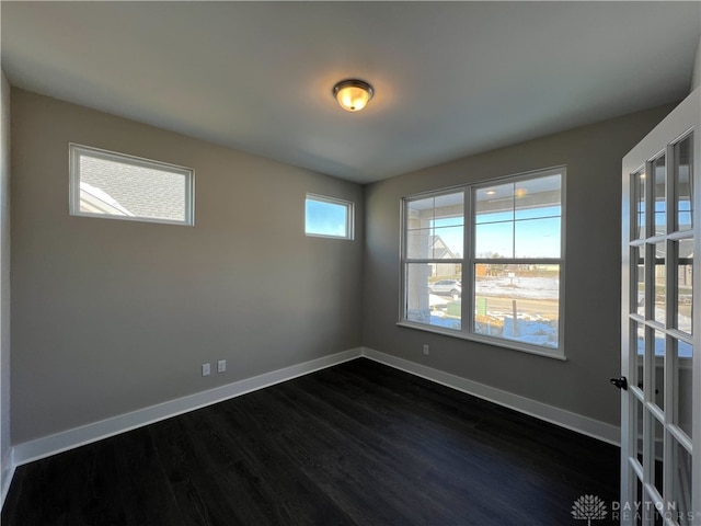 unfurnished room with dark wood-type flooring