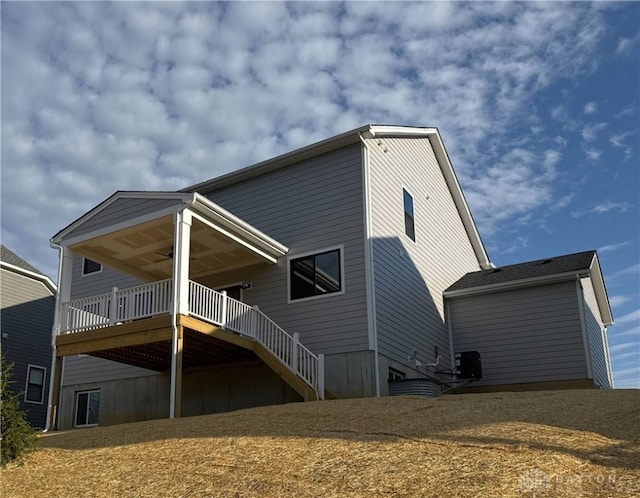 back of property with central air condition unit, stairs, ceiling fan, and a deck