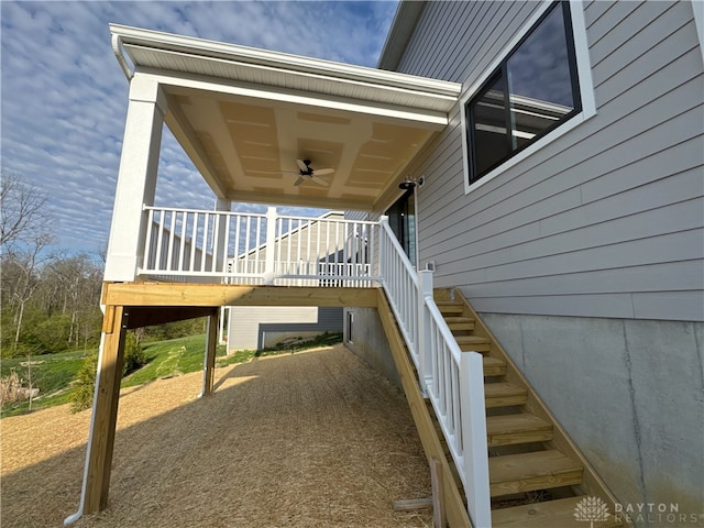 view of side of property with stairway and ceiling fan