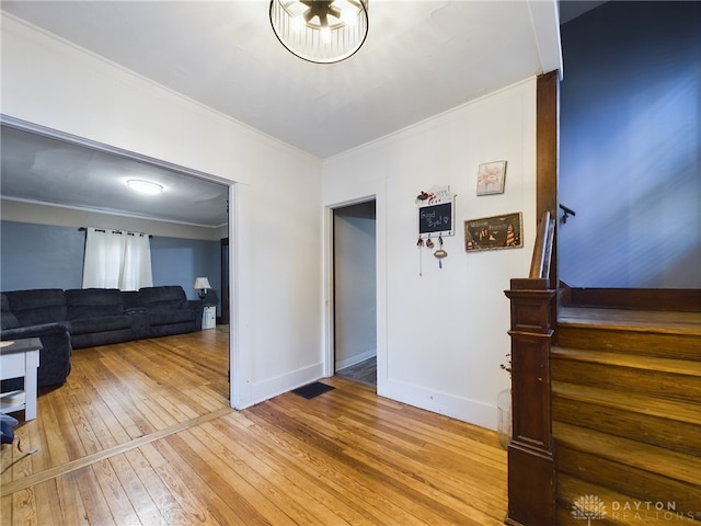 interior space with crown molding and light hardwood / wood-style flooring