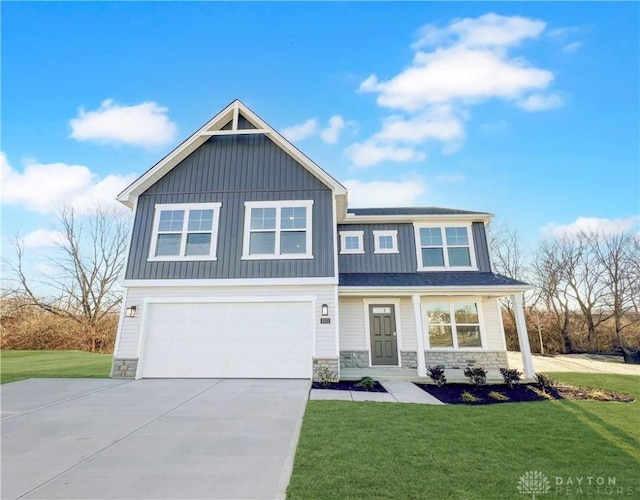 view of front of home featuring a front yard and a garage