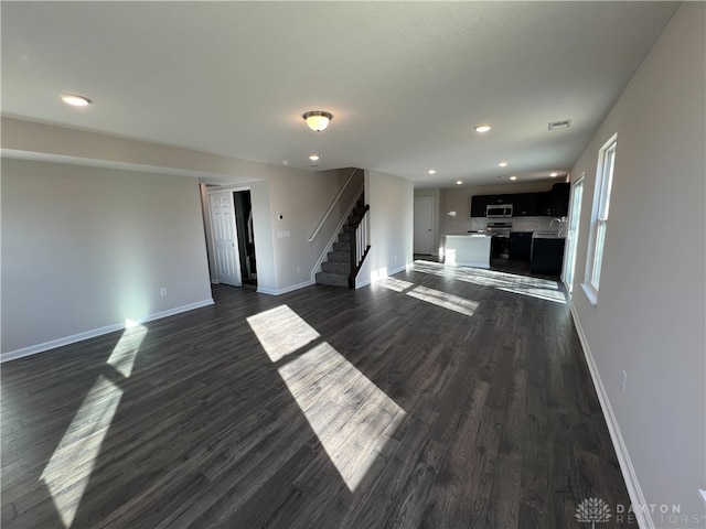 unfurnished living room with dark hardwood / wood-style flooring