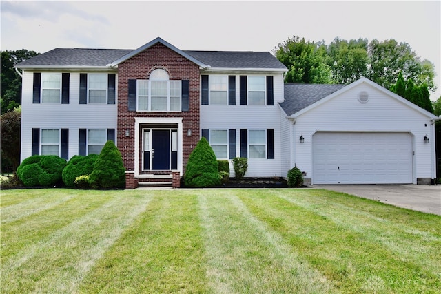 colonial house featuring a front lawn and a garage