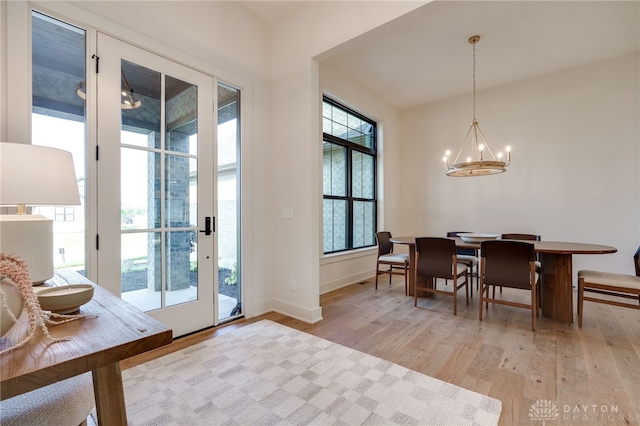 dining area featuring a notable chandelier and light hardwood / wood-style flooring