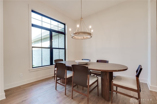 dining space featuring an inviting chandelier, light wood-type flooring, and a wealth of natural light