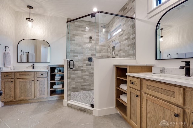 bathroom featuring vanity, walk in shower, and tile patterned flooring