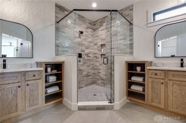 bathroom with vanity, tile patterned flooring, and a shower with door